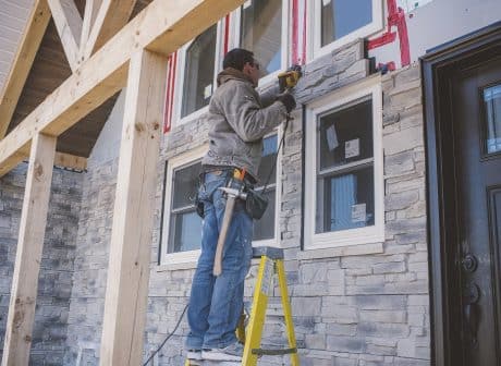 Builder tiling facade of house
