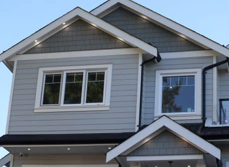 A low-angle view of modern houses in the background of sky