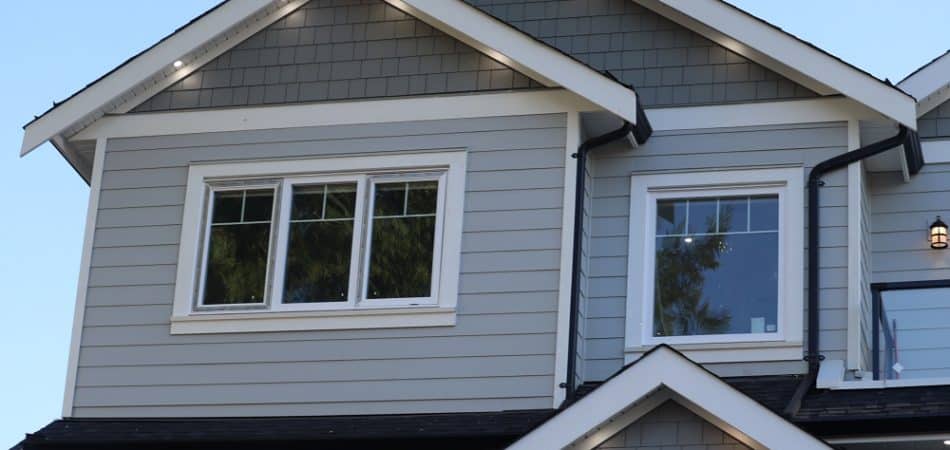 A low-angle view of modern houses in the background of sky