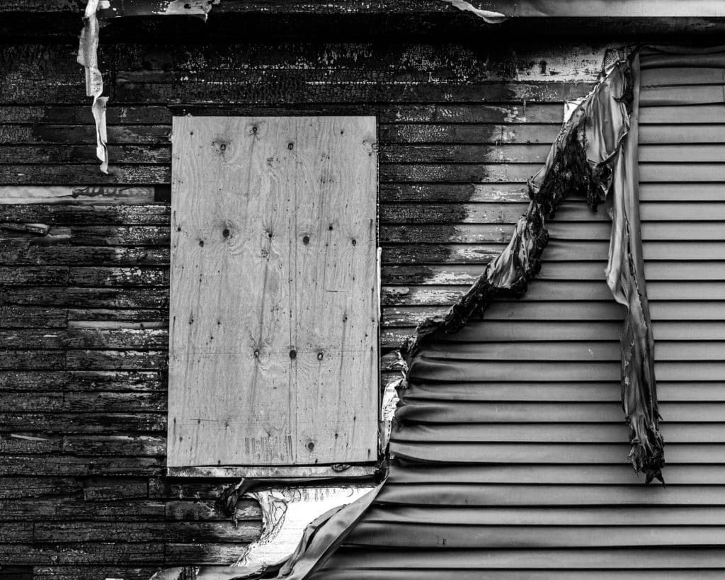 Damaged wood trim at the base of an exterior wall on a New Orleans home