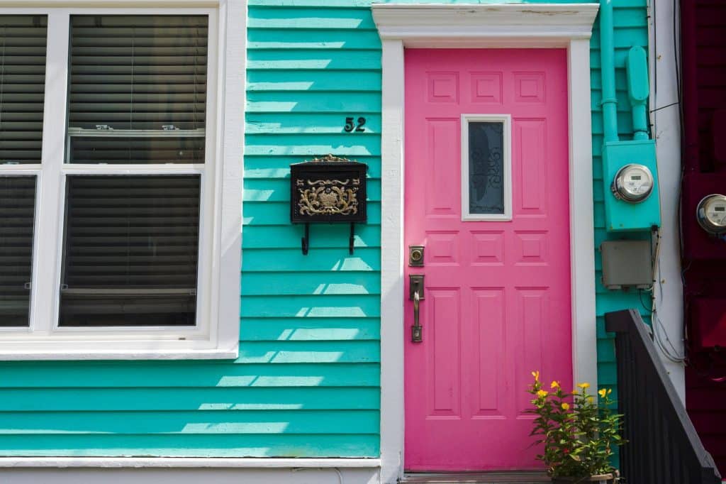 Painted lap siding and a pink front door, an exterior change that can need a St. Tammany Parish permit